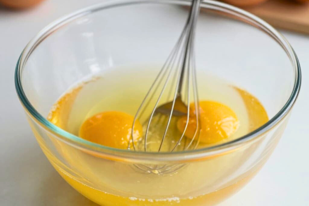 Eggs being whisked in a bowl for an air fryer omelet
