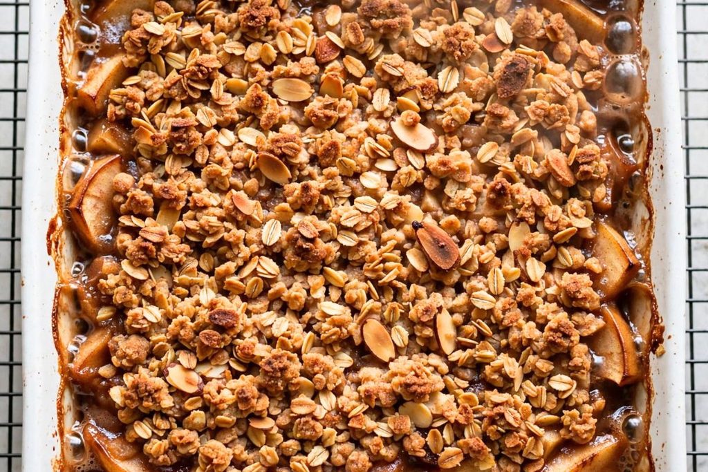 Fresh baked gluten free apple crisp with golden oat topping and bubbling apples