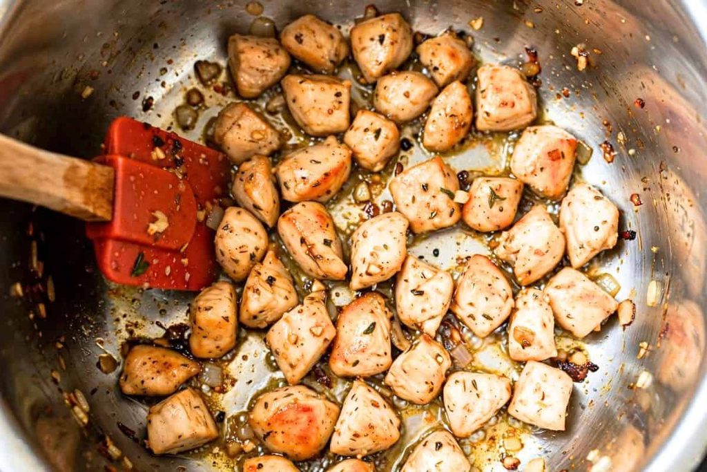 Chicken pieces sautéing in an Instant Pot