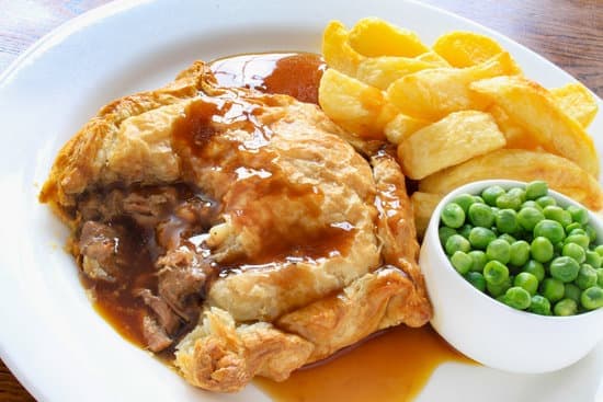 beef and guinness pot pie on a white plate