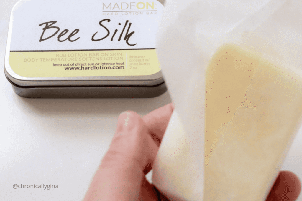 MadeOn Bee Silk hard lotion bar and metal tin, a natural skincare product made with beeswax, coconut oil, and shea butter, featured in a holiday gift guide by budget.