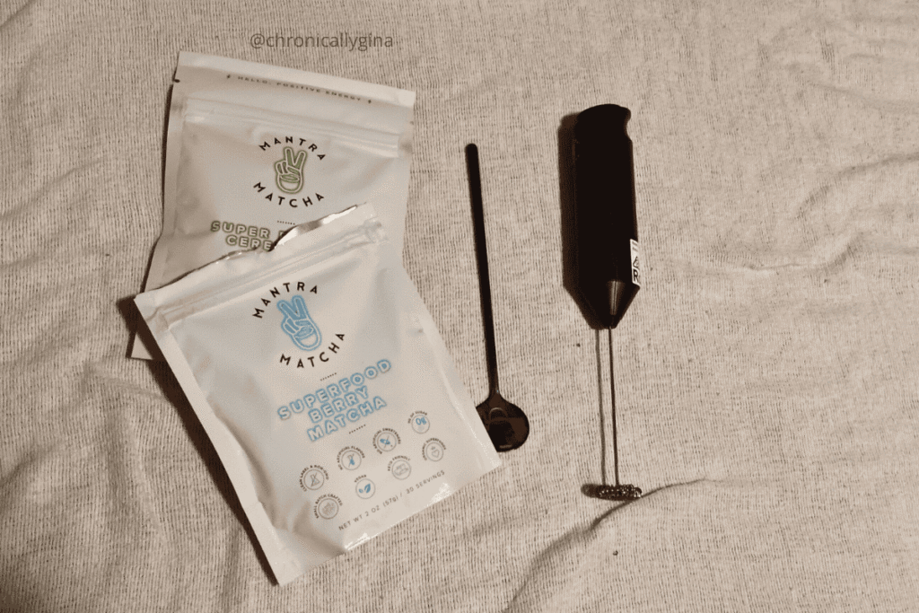 Mantra Matcha Superfood Berry Matcha and Super Ceremonial Matcha packets shown with a milk frother and spoon, perfect for a wellness or tea lover’s holiday gift guide.