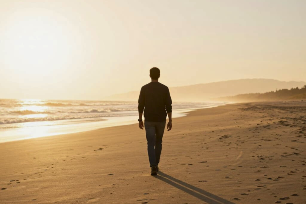 Individual walking toward sunrise symbolizing long-term recovery through an intensive outpatient program.
