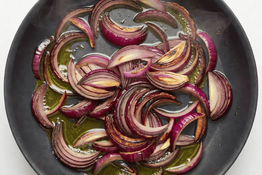 Red onions cooking in a skillet for lemon chicken